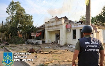 War crimes prosecutors' perso<em></em>nnel survey the damage in Kupyansk