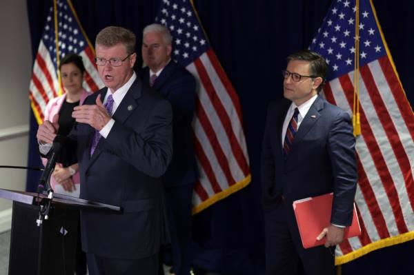 U.S. Representative Mark Amodei speaking at a podium while fellow House Republican leaders Elise Stefanik, Tom Emmer, and Mike Johnson listen intently at the Republican Natio<em></em>nal Committee headquarters