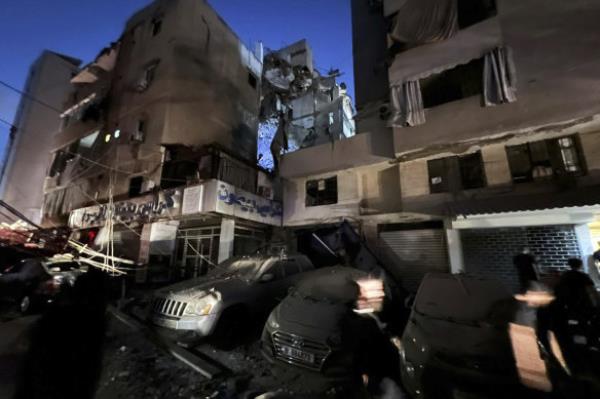 People inspect damaged cars in the southern suburbs of Beirut, Lebanon.