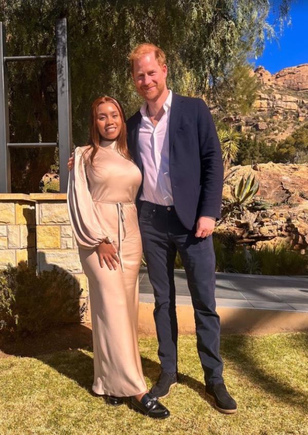 Prince Harry, dressed in a white shirt, jeans and dark jacket, posing with Princess Senate Seeiso of Lesotho in southern Africa