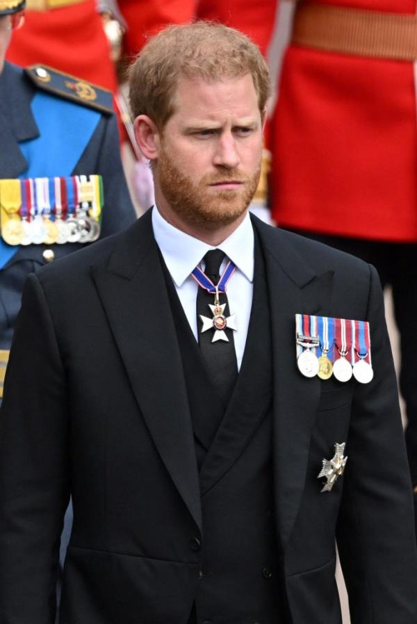 Prince Harry, Duke of Sussex, arriving in a suit adorned with medals at the state funeral and burial of Queen Elizabeth II at Windsor Castle, England