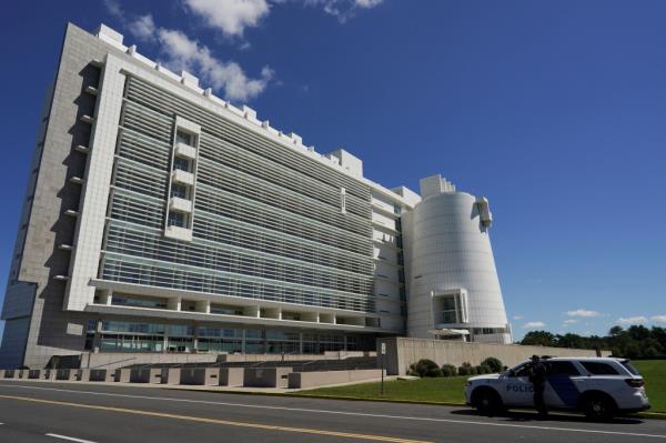 Police car parked outside Alfo<em></em>nse M. D'Amato U.S. Courthouse in Central Islip, New York, with George Santos appearing in court