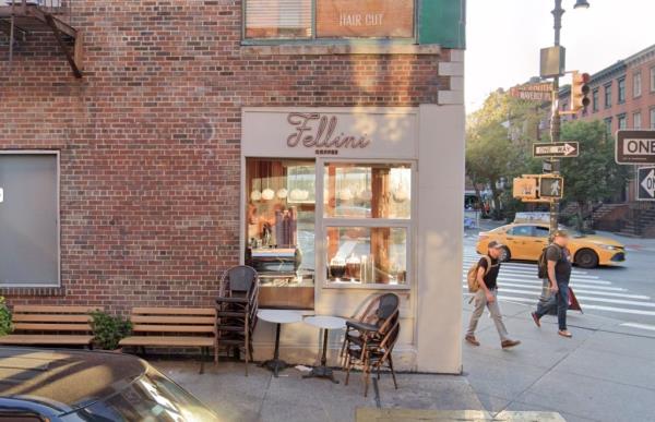 A screenshot of Fellini Coffee's page showing a brick building storefront with a table and chairs outside in West Village, New York, followed by a news des<em></em>cription a<em></em>bout unsanitary food handling practices.