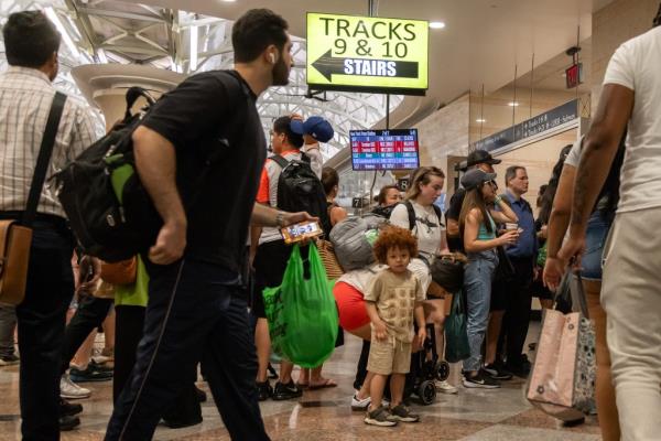 NJ Transit passengers boarding a train at Penn Station in New York City after experiencing delays