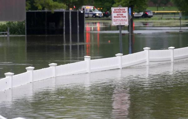 Flood waters rising to near the top of a fence at an entrance to Rogers Park in Danbury.