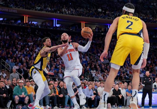 Knicks guard Jalen Brunson #11 goes up for a shot as Indiana Pacers guard Tyrese Haliburton #0 defends during the third quarter.