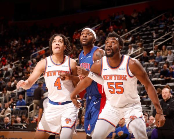 Ariel Hukporti of the New York Knicks boxing out during a basketball game against the Detroit Pistons at Little Caesars Arena in Detroit, Michigan.