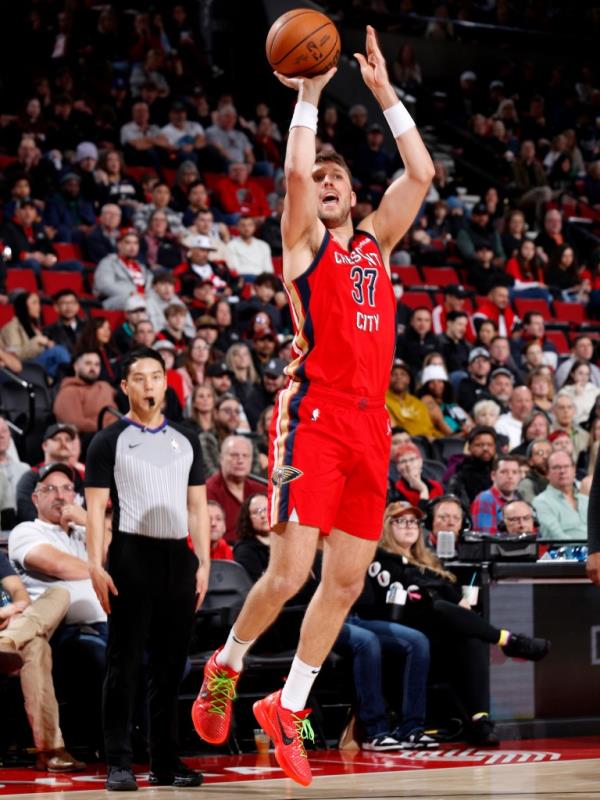 Matt Ryan, #37 of the New Orleans Pelicans, mid-jump, preparing to shoot a basketball during a game against the Portland Trail Blazers.