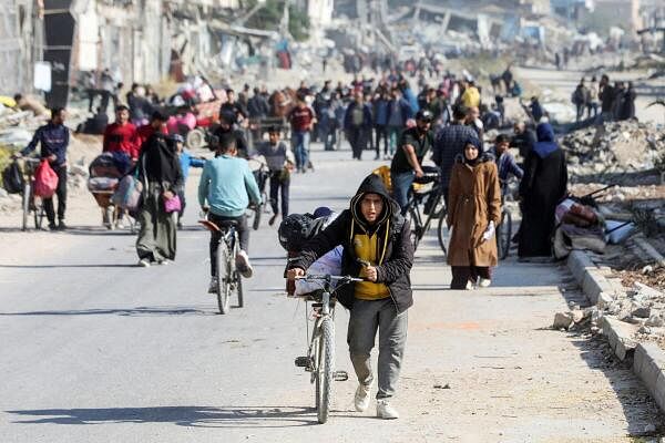 Displaced Palestinians make their way after fleeing the northern part of Gaza amid an Israeli military operation, in Gaza City.