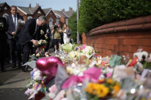 British Prime Minister Sir Keir Starmer leaves a floral tribute to the child victims of the Southport knife attack.