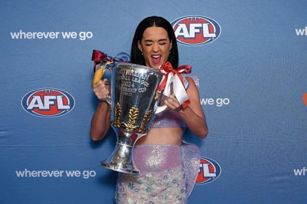 US pop superstar Katy Perry poses for photographs with the 2024 AFL Premiership trophy during a 2024 AFL Grand Final entertainment media preview at the MCG, in Melbourne, Thursday, September 26, 2024. (AAP Image/James Ross) NO ARCHIVING