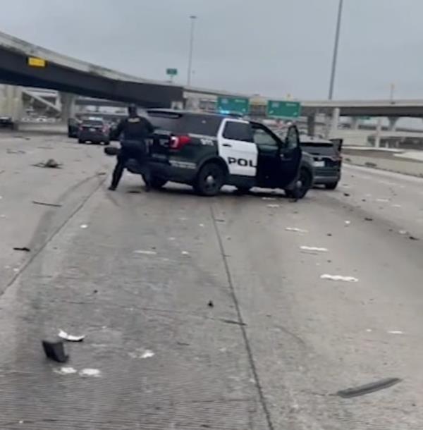 A screengrab of police hiding behind their vehicle during the shootout. 