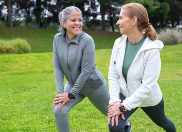 mature friends stretching, warming up for exercise together. co<em></em>ncept of workout habits to live longer