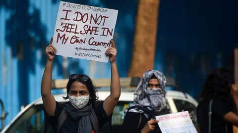 Getty Images Activists hold placards during a protest to co<em></em>ndemn the alleged gang rape and murder of a 19-year-old woman in Bool Garhi village of Uttar Pradesh state, in Mumbai on October 6, 2020.