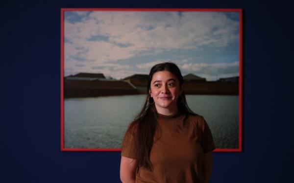 Artist Ngahuia Harrison with a work from exhibition Coastal Cannibals