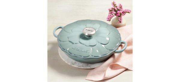 Le Creuset Signature Petal Braiser on table next to napkin and flowers