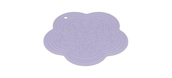 Purple Le Creuset Silicone Flower Trivet on white background