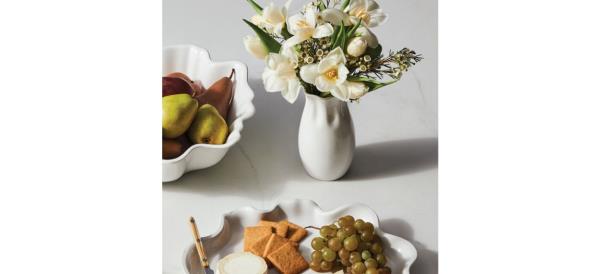 White Le Creuset Flower Petal Vase on table